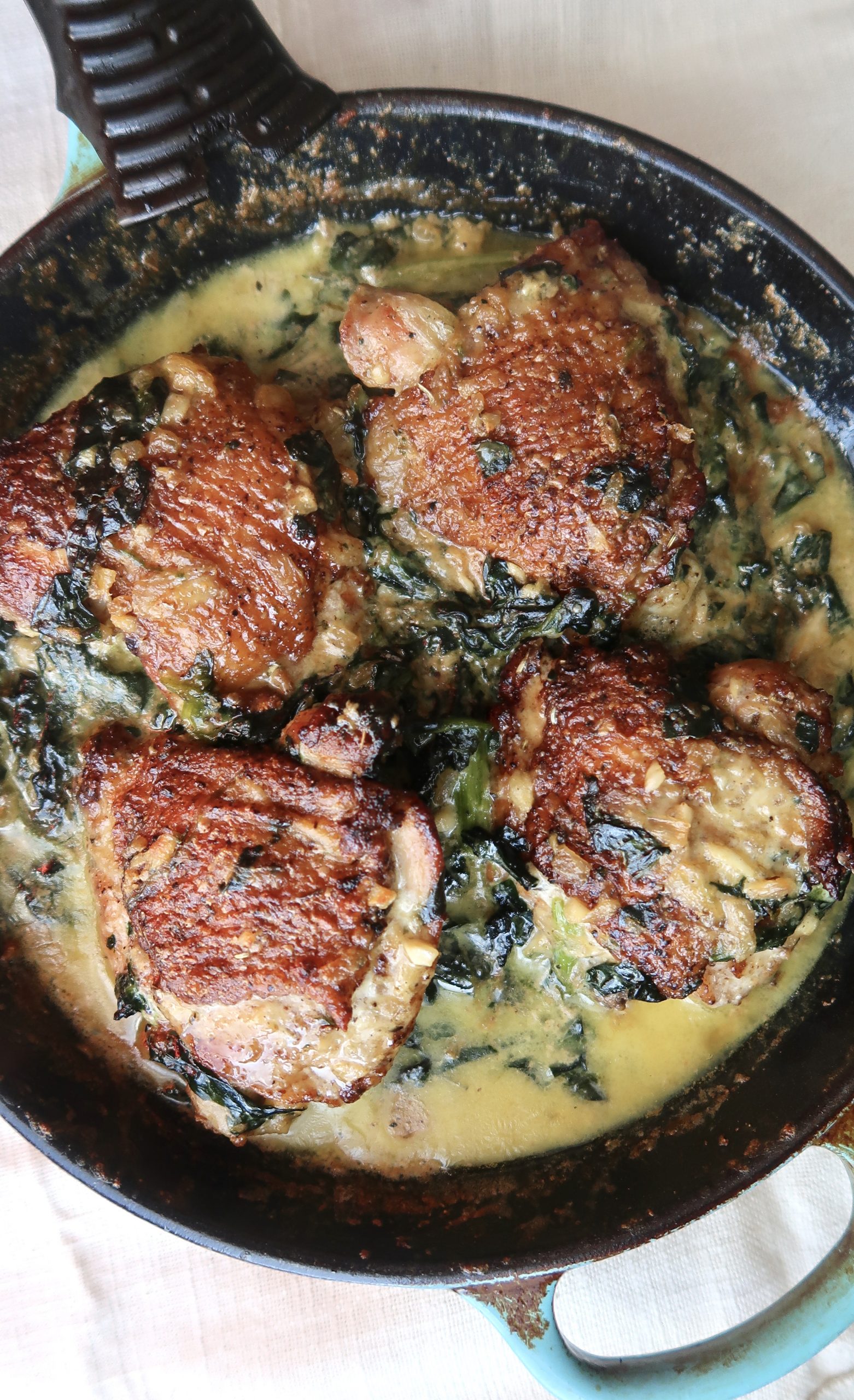 Oven-roasted chicken thighs in a garlic, spinach cream sauce - Asili Glam