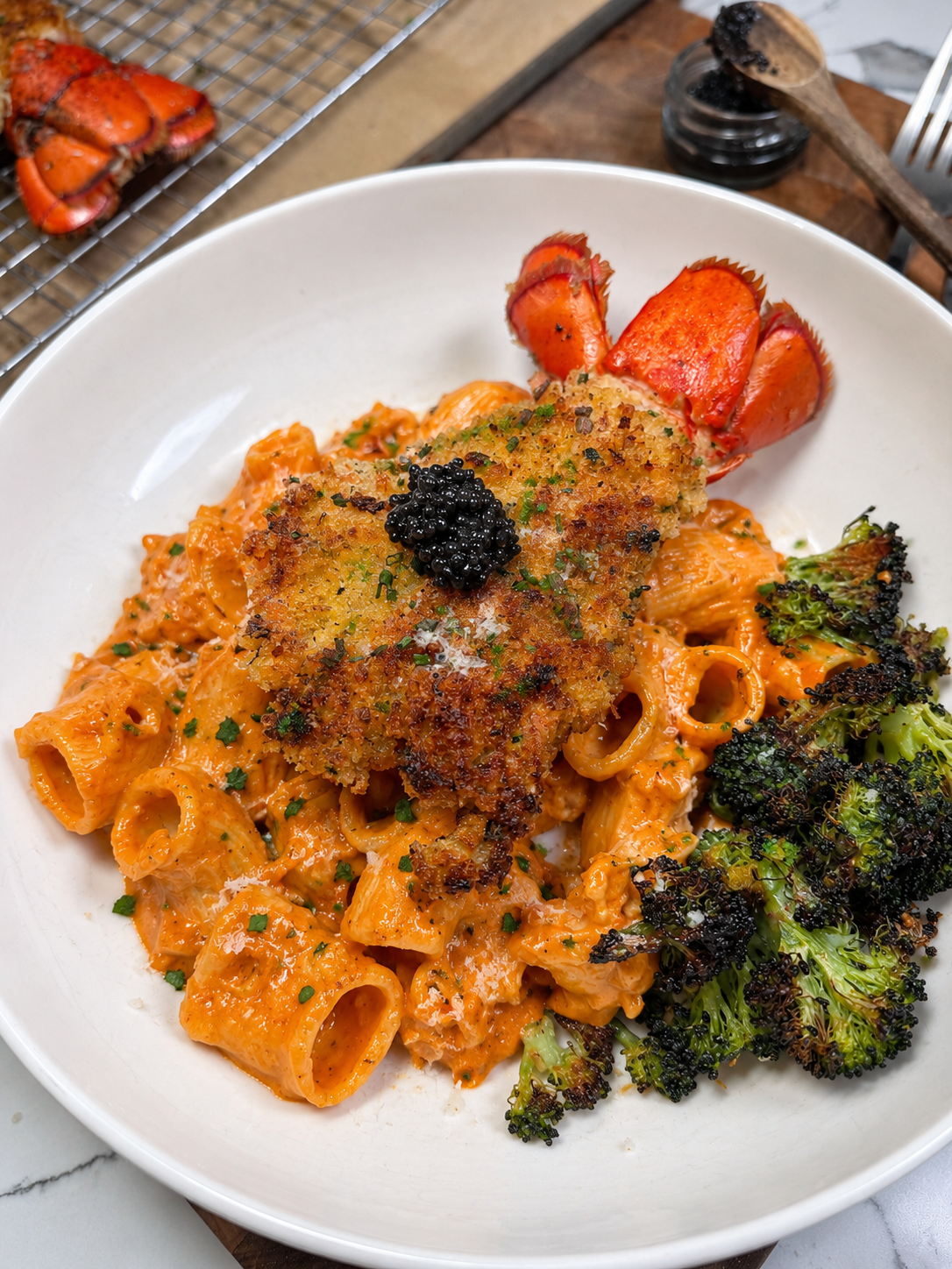 Crispy golden panko-breaded lobster cutlet topped with caviar, served over creamy rigatoni alla vodka with roasted broccoli, inspired by Locale Restaurant’s viral lobster cutlet in New Jersey.